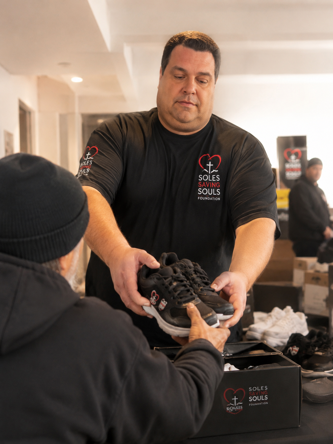 John Baldino giving shoes through Soles Saving Souls
